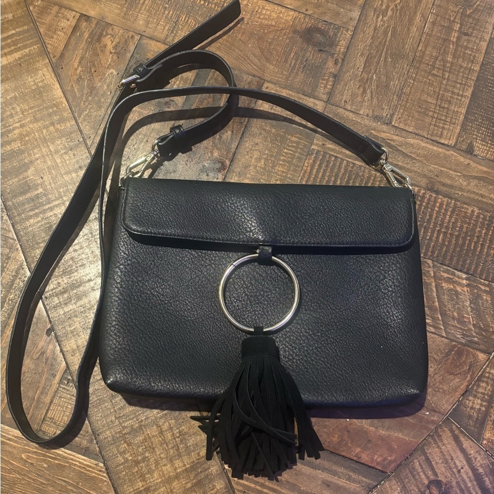 Anthropologie Street Level Black Faux Leather Crossbody Bag with Tassel Detail.
